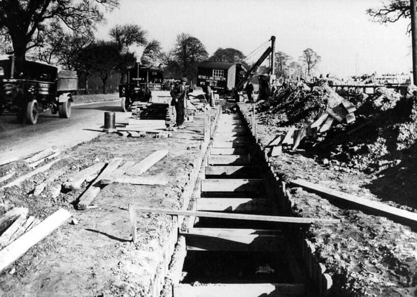 Historic photo of Bethell digging a trench