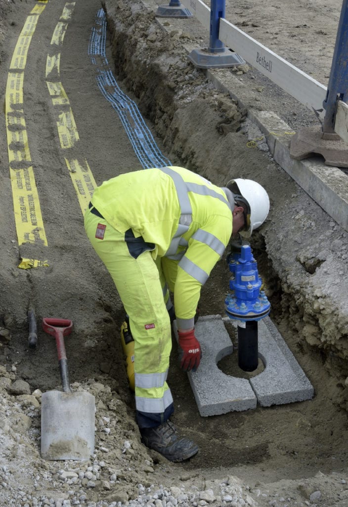 Bethell engineer installing a water connection