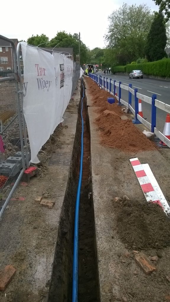Water pipe in a trench being installed a a housing development