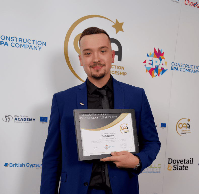 Construction apprentice Josh Holmes holding Construction Apprentice of the Year award