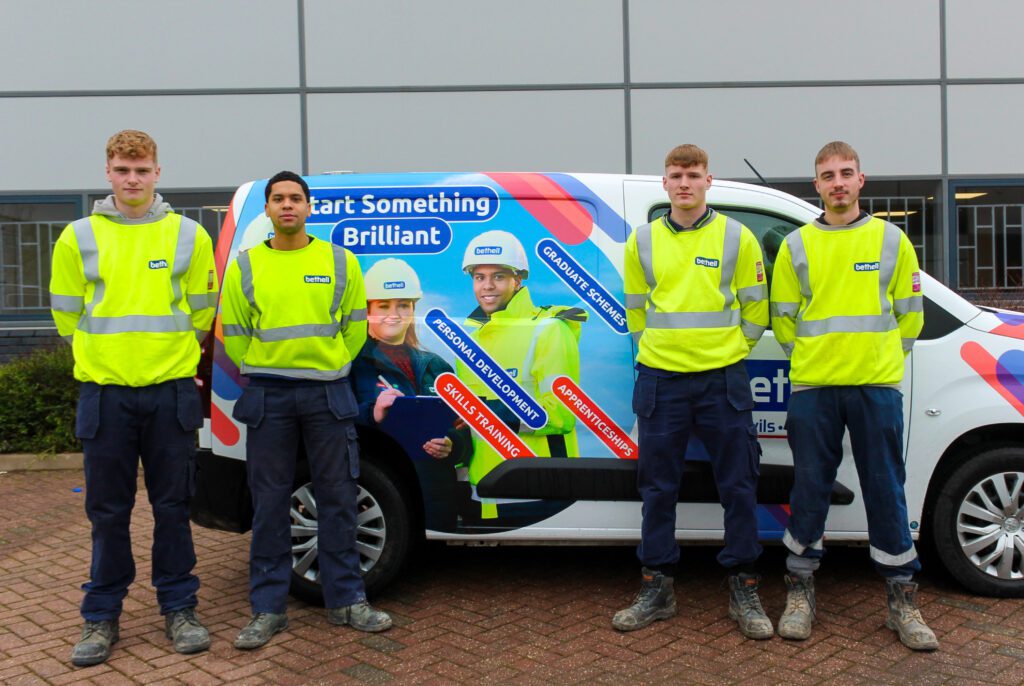 Four utility apprentices in front of a Bethell van