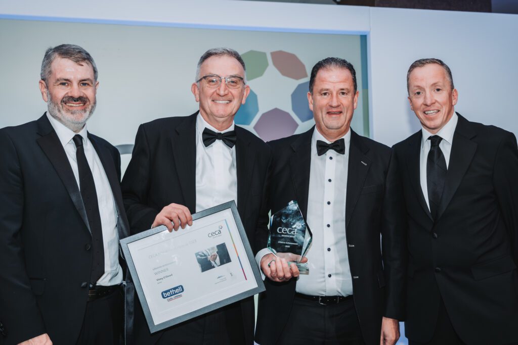 Four Bethell employees accepting an industry award